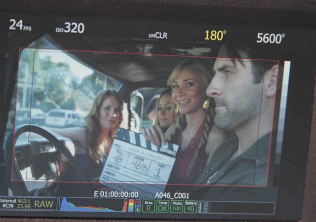 BTS Mika Boorem holds slate as cast Paige Howard Rick Faugno Elizabeth Masucci Patrick Zeller shoot scene