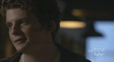 Continuum S1x03 - Alec smiles as he tells Kiera to put on the bluetooth headset