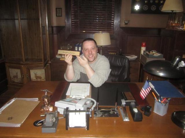 Chad Colvin at Sheriff Carter Office Desk Eureka during set visit