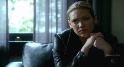 Fringe S5x11 - Olivia looks on with deeps emotions as September relates his circumstances