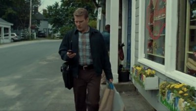 Haven S4x06 - The victim Seth is apparently reading a text message in front of the Haven Travel office