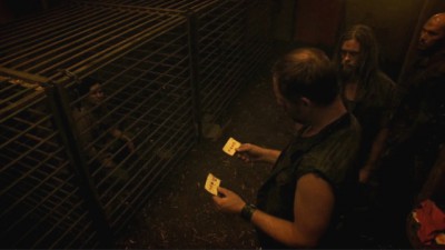 Revolution S2x02 - Guards take blood samples from Miles and Sheriff mason while caged outside the Red Door