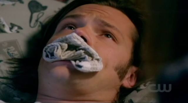 Supernatural S7x08 - Sam trying to talk with a rag in his mouth.